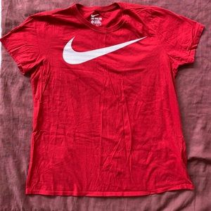 Red NIKE shirt w/ white Nike logo. Size XL.